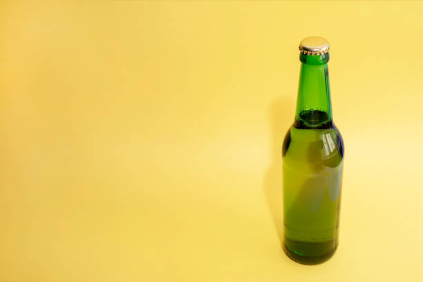 istock A bottle of beer on a yellow background 915701022