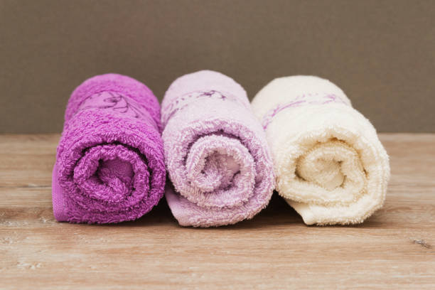 istock Multicolored towels on a wooden background 915701062