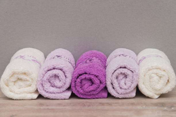 istock Multicolored towels on a wooden background 915701144