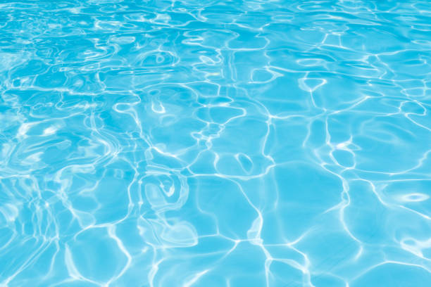 istock Blue and bright water surface and ripple wave with sun reflection in swimming pool 915712346