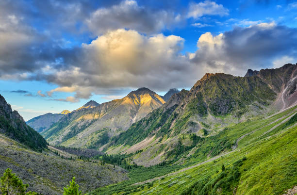 istock Evening sky with cumulus clouds over mountain valley 915713578