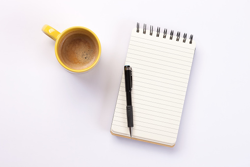 To do list and coffee on white background