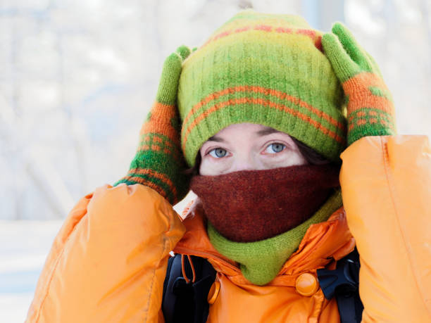 緑の冬帽子とスカーフを調整する女性のヘッド ショット - scarf hat green glove ストックフォトと画像