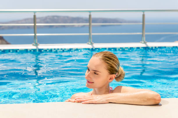 istock Pretty woman resting in swimming pool 915717234