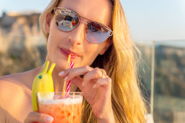 istock Pretty woman drinking funny cocktail 915717246