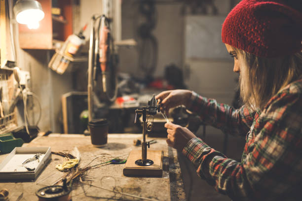 istock Young woman making fly for fishing 915721076