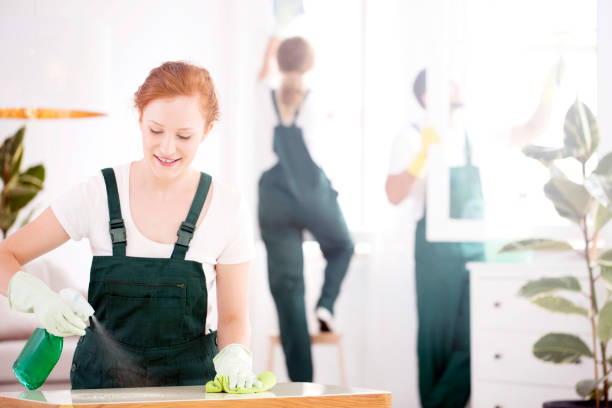 Woman spraying cleaning liquid