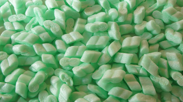 istock Background of pieces of green plastic foam used to protect objects inside boxes in a move 915729662
