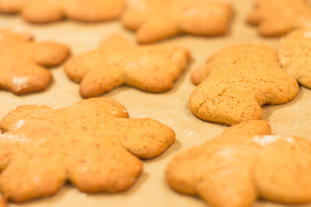 istock Ginger biscuits lie on a baking sheet. Cookies on baking paper. 915730888