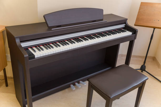 istock modern wooden black piano in music classrom isolated 915735490