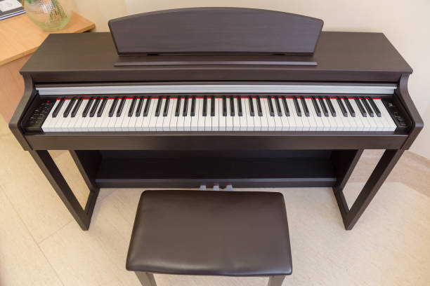 istock modern wooden black piano in music classrom isolated 915735722