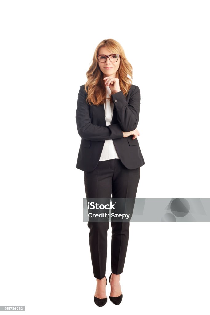 Attractive mature businesswoman Full length shot of a smiling executive businesswoman standing against at isolated white background. Businesswoman Stock Photo
