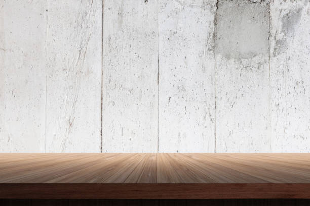 istock Cement wall background High resolution concrete texture concepts with wooden deck table and free copysapce for your text 915736586
