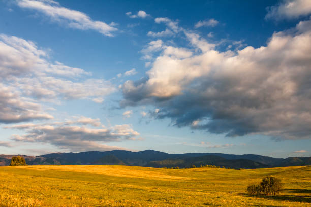istock Sunny landscape with mountains and blue sky with clouds. 915740044