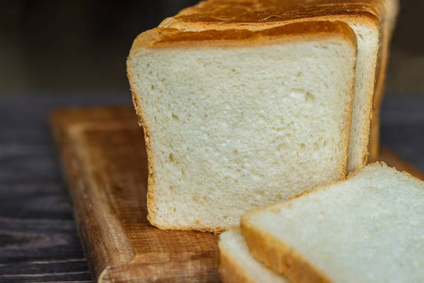 istock White bread sliced with slices on a wooden background close-up. 915740302