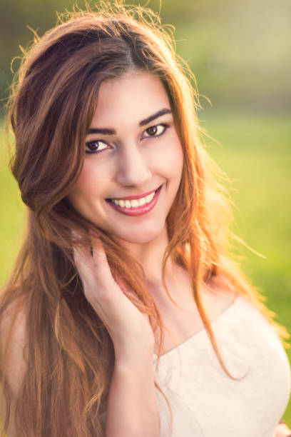 istock Young happy attractive woman posing in sunset 915747406