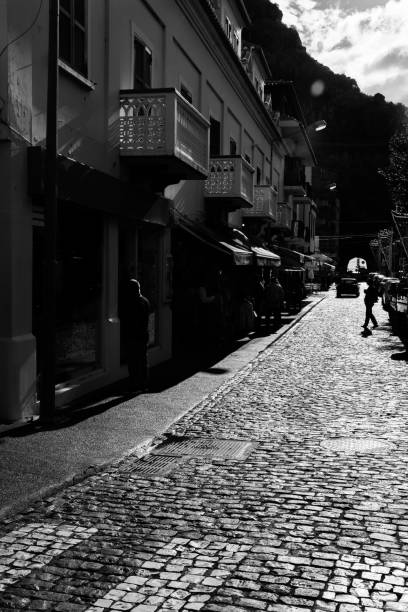 istock light and shadow on the street - monochrome 915747950