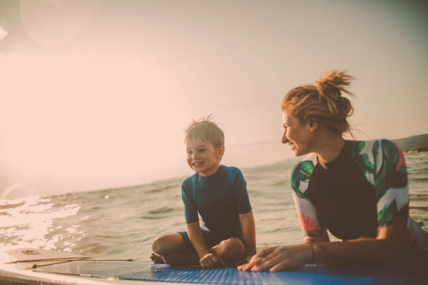 istock Mother and son enjoy paddle boarding 915748286