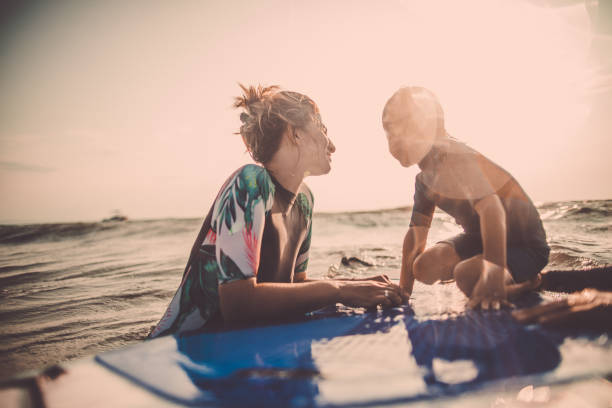 istock Mother and son enjoy paddle boarding 915748334