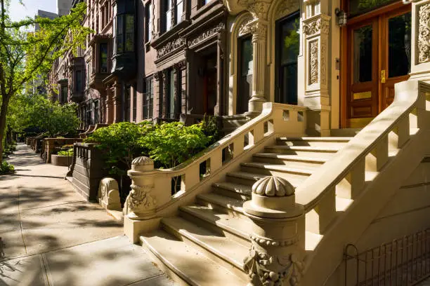 Brownstones with doorsteps and ornament in morning light. Upper West Side Street, Manhattan, New York City