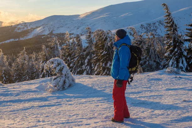 istock Hiker, with backpack, stands on the mountain ridge during dawn 915754488