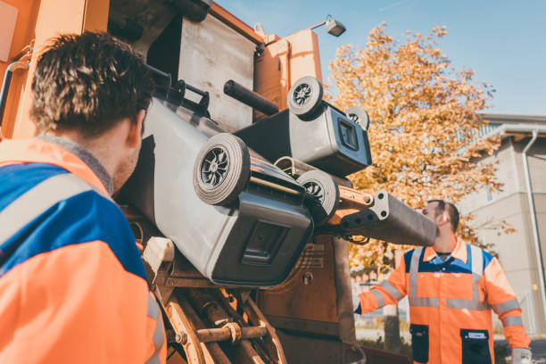 istock Worker emptying dustbin into waste vehicle 915761560