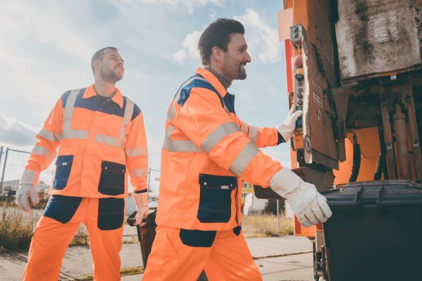 istock Two garbagemen working together on emptying dustbins 915761776