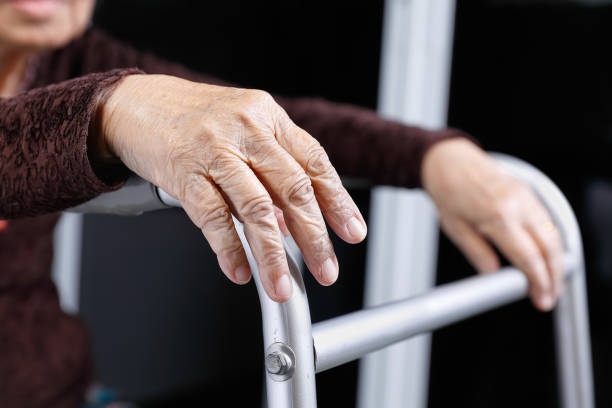 istock senior woman using a walker at home 915765602