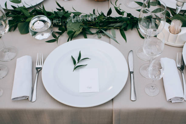 istock Wedding table setting decoration flowers and green leaves 915768170