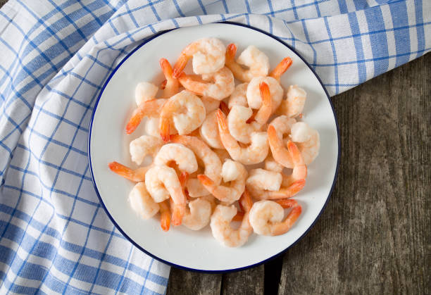 istock frozen shrimps on wooden surface 915777138