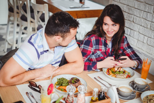 istock Young couple having lunch at restaurant 915777534