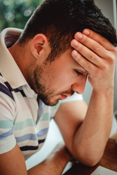 istock Young worried man sitting and thinking 915777542
