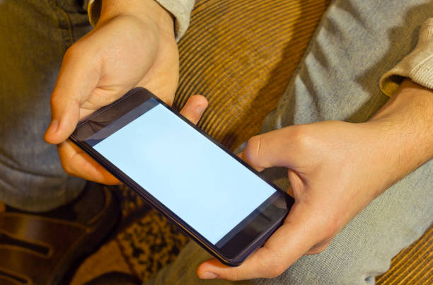istock Man’s hands with old smart phone 915779876