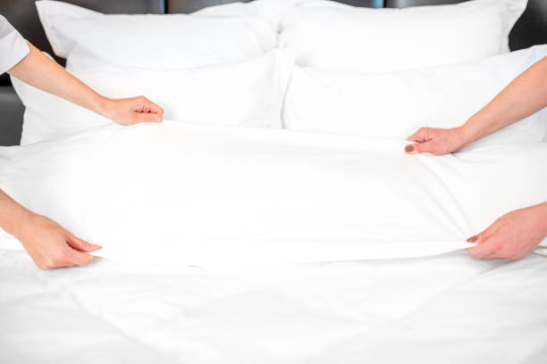 istock Chambermaids making a bed at the hotel 915780840