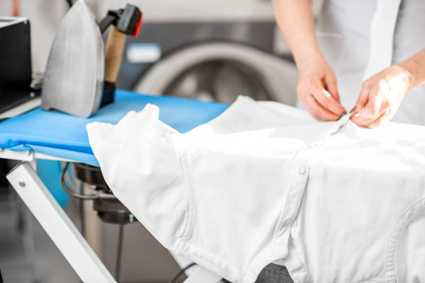 istock Ironing a white shirt on the board 915783746