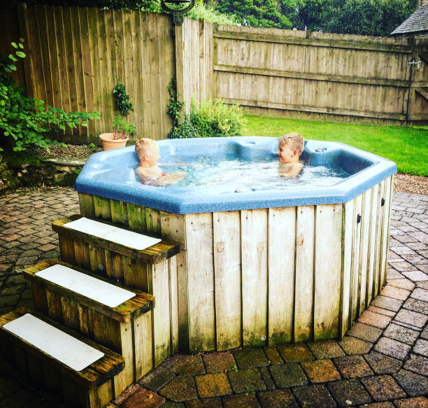 istock two boys relax in a hot tub 915786532