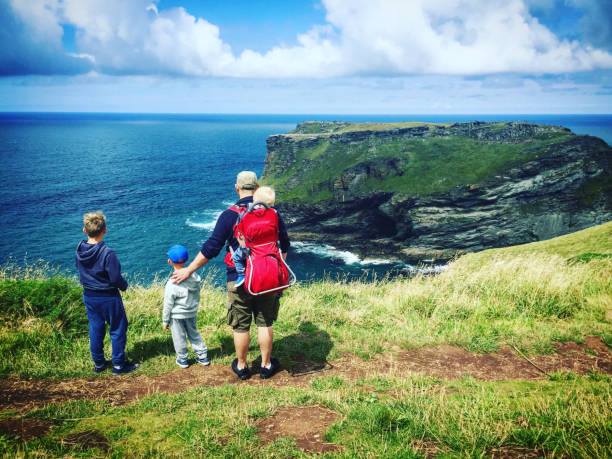 istock father with his three son's looking at the coastline Cornwall 915786596