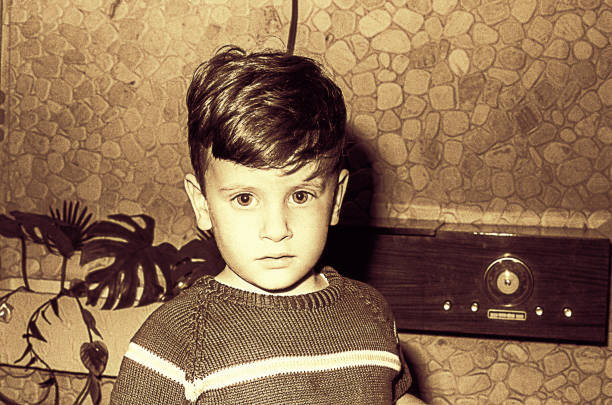 sepia toned vintage boy with old radio - 20th century style flash imagens e fotografias de stock