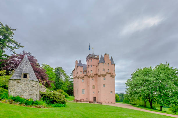 Craigievar Castle is a tall and slender building, built in pinkish slate with a massive lower structure surmounted by turrets and gargoyles. It was completed in 1626. Around the castle there are the scenic rolling foothills of the Grampian Mountains.
