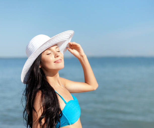 istock girl in bikini standing on the beach 915789058