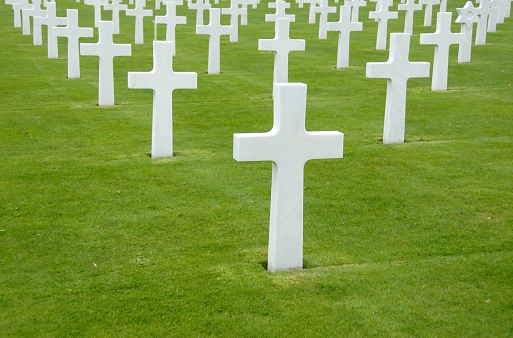 White crosses on green grass at World War II cemetery,Colleville-sur Mer,France.