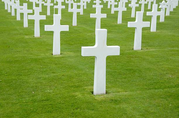 White crosses at World War II cemetery,Colleville-sur Mer,France. White crosses on green grass at World War II cemetery,Colleville-sur Mer,France. national cemetery stock pictures, royalty-free photos & images