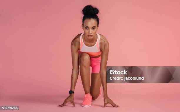 Sportswoman About To Start A Run Stock Photo - Download Image Now - Women, Sports Race, One Woman Only