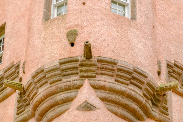 Craigievar Castle is a tall and slender building, built in pinkish slate with a massive lower structure surmounted by turrets and gargoyles. It was completed in 1626. Around the castle there are the scenic rolling foothills of the Grampian Mountains. Close-up.