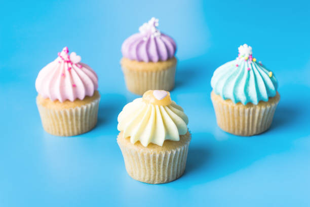 istock Colorful Pastel Cupcake on blue pastel background 915795784