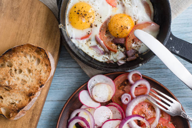istock Lunch in a rustic style pub - fried eggs, salad and toasted bread 915795900