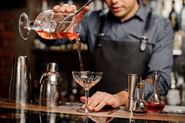 istock Bartender pours sweet cocktail in bocal 915796406
