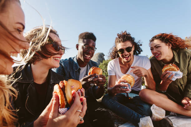 Young people having a picnic on mountain top