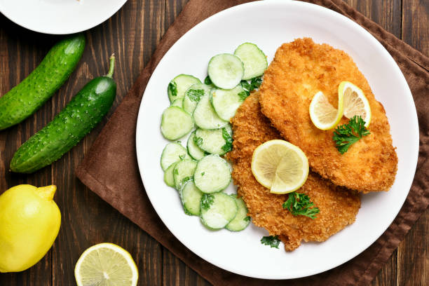 istock Tasty schnitzel with cucumber salad 915800450