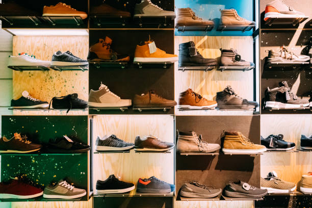 fashion casual male sneakers on shelves in store of shopping center - shoe store shoe shopping retail imagens e fotografias de stock